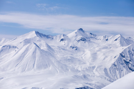 Breathtaking Snow-Capped Mountains Against a Clear Blue Sky - A Stunning Winter Landscape That...