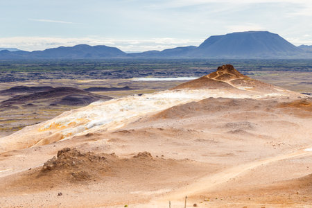 Breathtaking Landscape of an Icelandic Geothermal Field with Steaming Craters, Majestic Mountains, and Expansive Valleys: A Natural Marvel to Exploreの写真素材