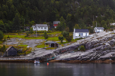 Serene Coastal Village Amidst Nature s Beauty: Captivating Homes Perched on Rocky Slopes Next to...