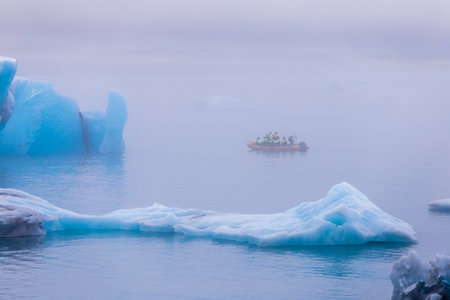 Exploring the Mystical Icebergs: A Journey through the Foggy Waters with Adventurers on a Small Boat...