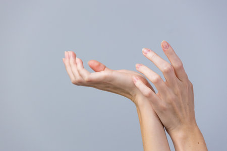 Elegant Hands in Motion Against a Minimalist Background Highlighting Graceful Gestures and Expressive Movements in a Contemporary Styleの写真素材