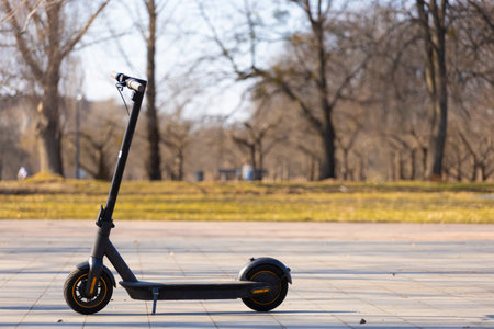 Exploring the Future of Urban Mobility with an Electric Scooter: A Stylish and Efficient Ride for Eco-Friendly Commuting in City Parks and Urban Areasの写真素材