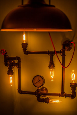 Modern Industrial Pipe Lamp Design Featuring Edison Bulbs and a Vintage Pressure Gauge for a Unique Home Decor Statementの写真素材