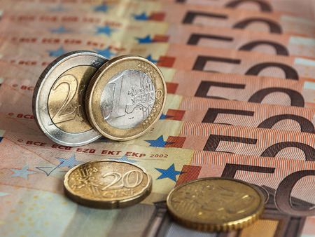 One and two euro, which is located among many banknotes of Europeの写真素材