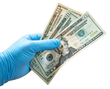 Hand in disposable glove isolated on white. Money in hand.の写真素材