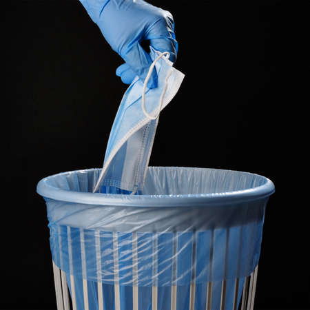 Dispose of the virus face shield in the trashcan after use. Don't litter the environment.の写真素材