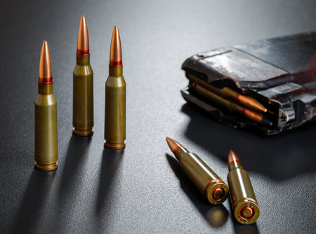 Ammunition for a automatic rifle on black surface with a magazineの写真素材