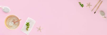 Flat lay accessories for hygiene and body care: pumice stone, wooden toothbrushes, cosmetic clay and cotton towel on pink background. Top view, flat lay, copy space.の写真素材