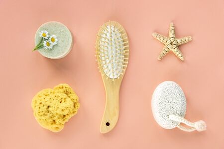 Herbal organic cosmetics and body care products. Flat lay on coral background. Top view, copy space.
