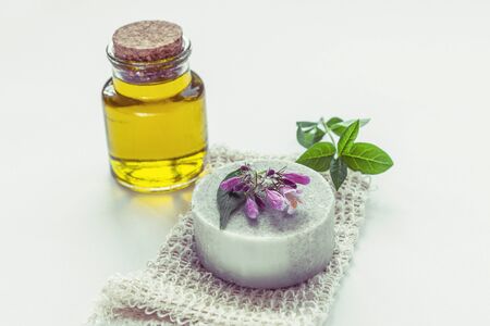 Homemade soap and organic oil bottle on white background, natural cosmetics concept.の写真素材
