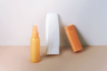 Cosmetics SPF for face and body, unbranded blank packages on yellow and white background.の写真素材
