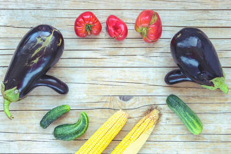 Home grown vegetables, ugly food, flat lay, wooden background, copy space.の写真素材