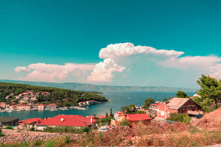 Beautiful view of Jelsa village bay with blue sky and clouds, Hvar island, Croatia.