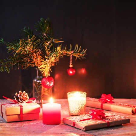 Christmas gifts, candles and fir twigs with toys, New Year concept, soft focus.の写真素材
