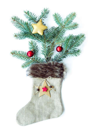 Christmas tree and toys in christmas sock made of sackcloth on white background. Flat lay, top view.の写真素材