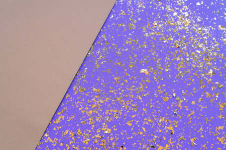 Festive beige and purple background with golden confetti, top view, flat lay. Copy space.の写真素材