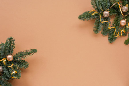 Fir branches with baubles on beige background. Christmas concept. Top view, flat lay, copy space.の写真素材