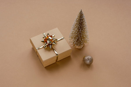New Year's gift, Christmas tree toy and bauble on beige background. Festive layout, top view.の写真素材