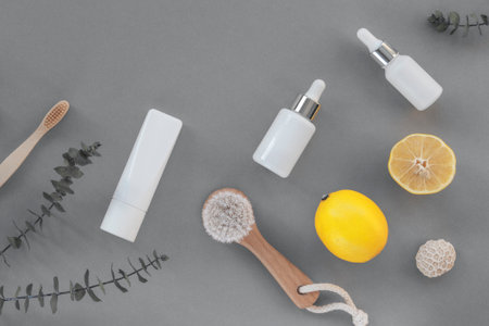 Wooden face brush, cosmetic oil and toothbrush. Eco-friendly cosmetics and accessories, yellow lemon fruits. Top view, flat lay, copy space. Color 2021.の写真素材