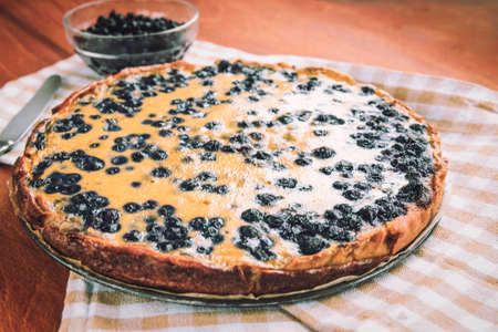 Sweet pastries, Blueberry pie on wooden table, top view.の写真素材