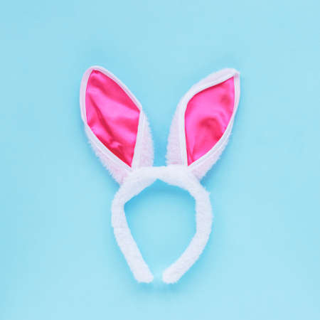 Flat lay accessory costume bunny ears on blue background. Easter concept.の写真素材