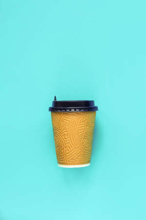 Disposable coffee container on blue background. Zero waste, green and conscious lifestyle concept. Top view, flat lay.の写真素材