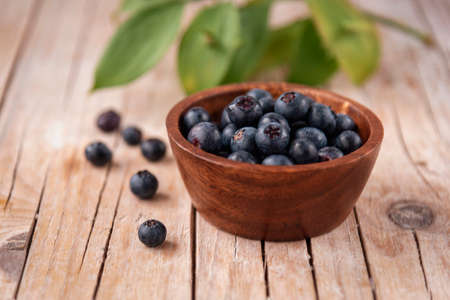 Bowl with blueberries on a wooden table, close up. Healthy food.の写真素材