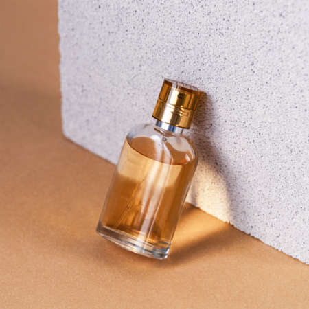 Bottle of perfume on natural stone background, beauty and fashion concept.