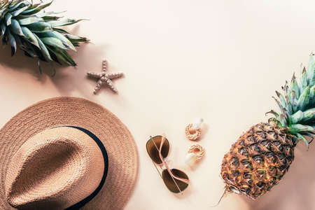 Womens summer accessories and pineapples. Beauty, fashion, summer vacation concept. Top view, flat lay, copy spaceの写真素材