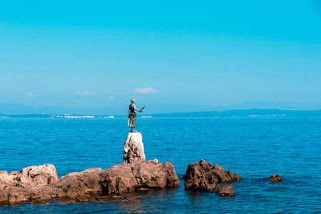 Sculpture of the girl with the seagull in hand on the shore in Opatija, Croatia.のeditorial素材