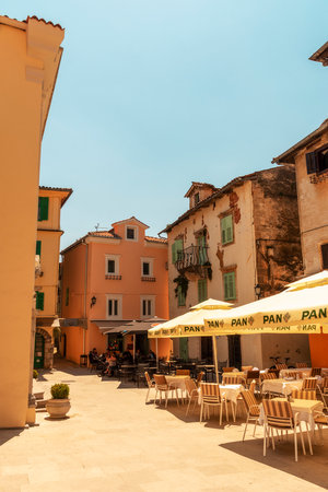 Lovran Croatia - 05 June 2021: Main square of Lovran town with restaurants and houses in traditional Mediterranean style, Istria region, Croatiaのeditorial素材