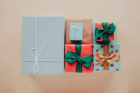 Gifts wrapped in colorful paper with bows, top view