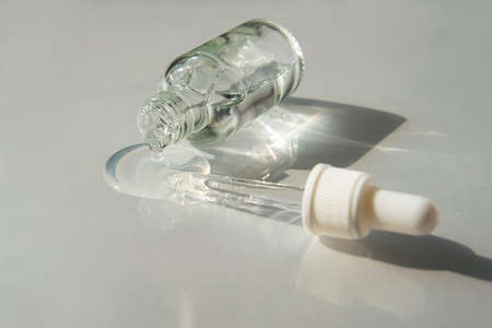 Bottle of Hyaluronic acid gel with pipette on light grey background. Trendy selfcare products.の写真素材