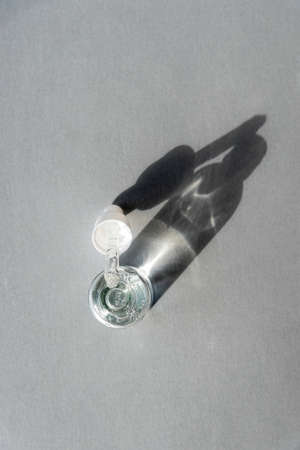 Bottle of Hyaluronic acid gel with pipette on light grey background. Trendy selfcare products. Sharp...