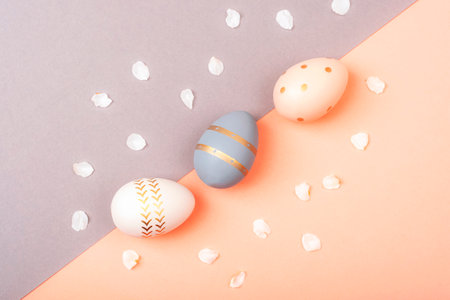 Colorful Easter eggs on pink and gray background. Top view, flat lay.の写真素材
