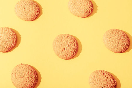 Homemade cookies on yellow background with sharp shadows. Top view, flat lay.の写真素材