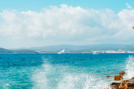 Ship sails along the shore with mountains. Peljesac, Croatia.の写真素材