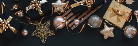 New Year gifts in black boxes, Christmas toys and garland on black background. Top view, flat layの写真素材