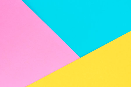 Yellow, pink and purple colored paper. Geometric empty paper background of three tones for copy space.の写真素材