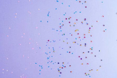 Golden confetti on purple background. Winter holidays, Christmas or birthday concept.の写真素材