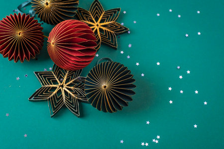 Paper honeycomb Christmas balls on dark green background with confetti. Christmas, New Year concept. Top view, flat lay, copy space.の写真素材