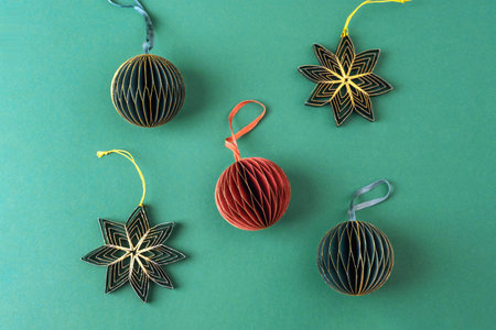 Paper fir tree toys on green background. Christmas concept. Top view, flat layの写真素材