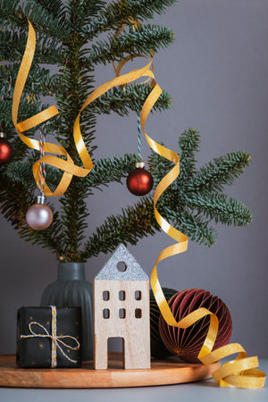 Wooden Christmas decorations and gift box, fir branches on gray background. Christmas or New Year greeting card. Closeupの写真素材