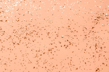 Festive background with shiny confetti. Holiday concept. Color of the Year 2024 Peach Fuzzの写真素材