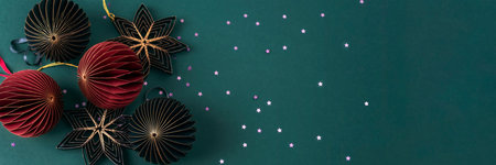 Banner with paper honeycomb Christmas balls on dark green background with confetti. Christmas, New Year concept. Top view, flat lay, copy space.の写真素材