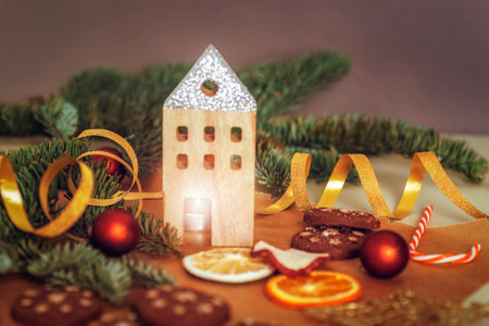 Christmas decorations with burning candle, baubles and dried fruits on dark background. New year concept. Selective focus.の写真素材