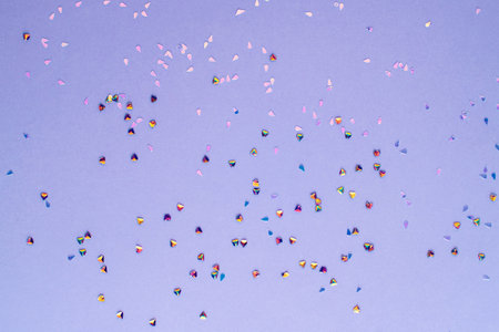 Golden confetti on purple background. Winter holidays, Christmas or birthday concept.の写真素材