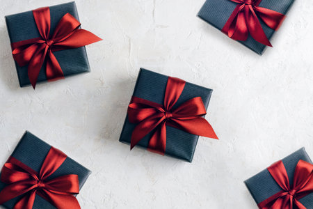 Present boxes with bow on white textured background. Top view, flat lay.の写真素材