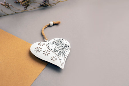Vintage toy heart and flowers on gray background. Valentines day concept, top view, flat lay, copy...