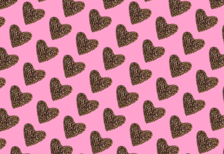 Pattern of hearts made from coffee beans on pink background. Valentines day concept.の写真素材